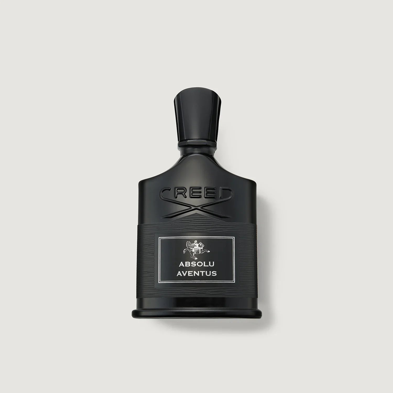 Black Creed Absolu Aventus perfume bottle on a light gray background